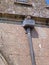 English gargoyle at drain at rural old village church, nearly a ruin