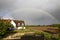 English home with rainbow in countryside