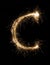 English Letter C from sparklers alphabet on black background.