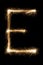 English Letter E from sparklers alphabet on black background.