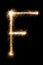 English Letter F from sparklers alphabet on black background.