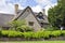 English stone house with chimneys in a rural village