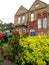 English street with typical brick houses and front gardens in front of them