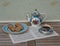 English teacup with saucer, teapot and a cake plate with cookies, fine bone china porcelain, on a sheet of music
