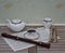 English teacup with saucer, teapot and sugar bowl, metronome for music and a block flute on a sheet of music