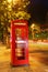 English telephone booth in the night with traffic light trails