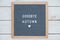 English text goodbye autumn on a letter Board in white letters on a gray background and a symbol of heart