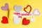 English text Happy Valentine written in red letters on a yellow card with love hearts