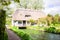 English thatched cottage over flowing river