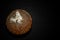 English translation of the Chinese fortune-top view badly moldy moon cake on a dark background