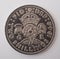 An English two shilling coin photographed against a white background