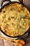 English vegetarian Bubble & Squeak of potatoes with cabbage and brussels sprouts close-up in a frying pan. Vertical top view from