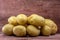 English white potatoes Solanum tuberosum on pink colored wood background