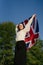 An English woman with the British flag dances in nature, success and happiness