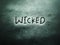 the english word wicked on the grunge rough grain wall texture background