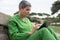 Engrossed senior woman reading electronic book in park