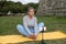 Engrossed woman with grey hair doing yoga in park