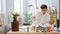 Engrossed young hispanic man, an aspiring artist, drawing a vibrant bouquet of flowers on paper in a cozy art studio