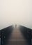 An Enigmatic Encounter: A Figure on a Foggy Bridge, Observed fro
