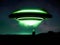 Enigmatic Encounter: Man Stands Before a Green UFO