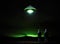Enigmatic Encounter: Two Figures Mesmerized by a Vibrant Green UFO in Night Sky