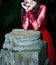 Enigmatic Gothic Beauty - Slender Woman Pondering in Crimson Red Elegance