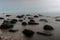 Enigmatic Waters: Long Exposure Unveiling Stones Shrouded in the Sea\\\'s Mystic Embrace