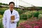 Enior Scientist holding taplet and smiling during checking chrysanthemum