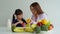 Enjoy Asian mom teaching a little daughter holding knife cut fresh vegetables, Happy family mother and child girl preparing