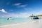 Enjoy benefits being beside sea. Sea turquoise water bungalow and ship near beach. Vacation sea sand beach tropical