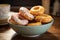 Enjoy a delightful ceramic bowl filled with freshly glazed donuts