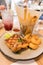 Enjoy a meal with grilled chicken steak, fried shrimps, chips, ketchup and Lemonade.