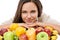 Enjoy natures bounty. Portrait of an attractive young woman with a selection of fruit in front of her.