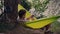 Enjoy weekend holiday. Man relaxes in hammock suspended from trees in forest near lake after riding mountain bike