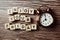 Enjoy Your Friday alphabet letter with alarm clock on wooden background