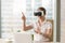 Enjoyed young woman using VR headset with gestures