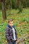 Enjoying autumn time. Little boy on autumn landscape. Little child walk in autumn forest. Small boy play on fresh air