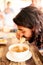 Enjoying a bowl full of noodles. Shot of a young man eating a bowl of noodles in a restaurant in Thailand.