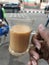 Enjoying a Cup of Milk Tea on the Street