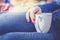 Enjoying a cup of tea: Close up of young woman with red nail polish and a cup of tea