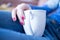 Enjoying a cup of tea: Close up of young woman with red nail polish and a cup of tea