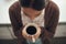 Enjoying a dark and soothing cup. High angle shot of a young woman drinking coffee at home.