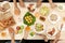 Enjoying dinner with friends.  Top view of group of people having dinner together while sitting at wooden table