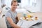 Enjoying his weekend pleasures. Portrait of a handsome man eating breakfast while reading the morning paper.