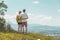 Enjoying the idyllic mountain landscape: Couple is standing on idyllic meadow and enjoying the view over the far away city of