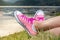 Enjoying by lake. Woman wearing pink sneakers