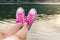 Enjoying by lake. Woman wearing pink sneakers