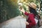 Enjoying moment woman backpacker and selfie in the road and forest background