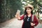 Enjoying moment woman backpacker and selfie in the road and forest background