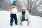 Enjoying nature wintertime. Father and son making snowball on winter white background. Happy family plaing with a
